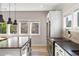Bright kitchen featuring stainless steel appliances, modern cabinetry, and a large island with black countertops at 611 King Arnold St, Atlanta, GA 30354