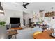 Open-concept living room featuring hardwood floors, modern lighting, a television, and stylish decor at 611 King Arnold St, Atlanta, GA 30354