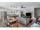 Modern living space featuring a stainless steel refrigerator, a kitchen island, hardwood floors and black pendant lighting at 611 King Arnold St, Atlanta, GA 30354