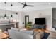 Relaxing open-concept living room featuring hardwood floors, modern lighting, a television, and an eat-in kitchen at 611 King Arnold St, Atlanta, GA 30354