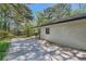 Spacious backyard with mature trees, patio area, and a brick house, perfect for outdoor living and entertainment at 1679 Hollyhock Ter, Decatur, GA 30032