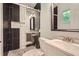 Modern bathroom featuring stylish black and white tile and glass shower enclosure at 1679 Hollyhock Ter, Decatur, GA 30032