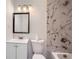 Bathroom featuring a tiled shower, white vanity, and modern fixtures at 1679 Hollyhock Ter, Decatur, GA 30032