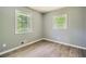 Bedroom featuring wood-look floors, neutral walls, and two sunny windows at 1679 Hollyhock Ter, Decatur, GA 30032