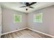 Bedroom featuring wood-look floors, neutral walls, and two sunny windows at 1679 Hollyhock Ter, Decatur, GA 30032