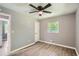 Neutral bedroom with a ceiling fan and wood-look flooring at 1679 Hollyhock Ter, Decatur, GA 30032