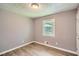 Bedroom with wood-look flooring, neutral walls, one window, and white trim at 1679 Hollyhock Ter, Decatur, GA 30032