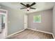 Bedroom featuring wood-look floors, neutral walls, ceiling fan and one sunny window at 1679 Hollyhock Ter, Decatur, GA 30032