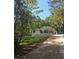 Charming home with a covered front porch nestled among mature trees at 1679 Hollyhock Ter, Decatur, GA 30032