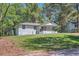 Charming white-painted home featuring a covered front porch and lush green lawn at 1679 Hollyhock Ter, Decatur, GA 30032