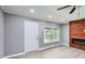 Living room with gray walls, wood-look flooring, ceiling fan and a modern fireplace at 1679 Hollyhock Ter, Decatur, GA 30032