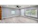 Open living room with stylish floors, a fan, and natural light from large windows at 1679 Hollyhock Ter, Decatur, GA 30032