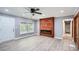 Living room with gray walls, wood-look flooring, ceiling fan and a modern fireplace at 1679 Hollyhock Ter, Decatur, GA 30032