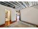 Bedroom featuring exposed ceiling, hardwood floors, and an open doorway to the kitchen at 791 Wylie Se St # 102, Atlanta, GA 30312
