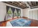 Bedroom with exposed ceiling, hardwood floors, large window, and closet at 791 Wylie Se St # 102, Atlanta, GA 30312