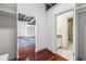 Hallway view into bedroom and bathroom with wood flooring, exposed ceiling, and modern finishes at 791 Wylie Se St # 102, Atlanta, GA 30312