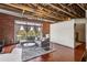Bright living room with hardwood floors, exposed ceiling, and large windows with neighborhood views at 791 Wylie Se St # 102, Atlanta, GA 30312