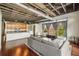 Open-concept living room with hardwood floors, exposed ceiling, and large windows providing natural light at 791 Wylie Se St # 102, Atlanta, GA 30312