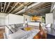 Comfortable living room with open kitchen, hardwood floors, exposed ceiling, and natural light at 791 Wylie Se St # 102, Atlanta, GA 30312
