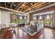 Well-lit living room with hardwood floors, exposed ceiling, and large windows offer neighborhood views at 791 Wylie Se St # 102, Atlanta, GA 30312