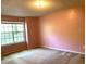 Spacious bedroom featuring wall-to-wall carpet and a large window for ample natural light at 997 Timbervale Ln, Lithonia, GA 30058