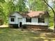 Charming single-Gathering home with a well-maintained lawn and mature trees creating a private, wooded setting at 997 Timbervale Ln, Lithonia, GA 30058