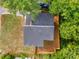 Aerial view of the home with a well-maintained roof and fenced yard surrounded by lush greenery at 1335 Elizabeth Ave Sw, Atlanta, GA 30310