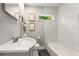Cozy bathroom with a classic white tub, shower, modern fixtures, and subway tile surround at 1335 Elizabeth Ave Sw, Atlanta, GA 30310