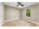 Minimalist bedroom features a ceiling fan, large window, and wood-look flooring at 1335 Elizabeth Ave Sw, Atlanta, GA 30310