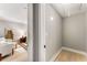 Hallway leading to bedroom and living area with hardwood floors, neutral colors, and cozy accents at 1335 Elizabeth Ave Sw, Atlanta, GA 30310