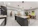 Open kitchen with large island, gray cabinets, pendant lighting, and adjacent dining area at 1335 Elizabeth Ave Sw, Atlanta, GA 30310