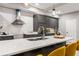 Close-up of a kitchen island with marble countertops, a stainless steel range hood, and modern cabinetry at 1335 Elizabeth Ave Sw, Atlanta, GA 30310