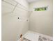 Bright laundry room features geometric tile flooring, storage shelf, and window for ample natural light at 1335 Elizabeth Ave Sw, Atlanta, GA 30310