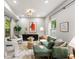 Bright living room featuring a comfortable green sofa, stylish decor, and large windows at 1335 Elizabeth Ave Sw, Atlanta, GA 30310