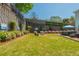 Serene backyard space featuring a hot tub and a hammock with lush landscaping and retaining walls at 2075 Old Georgian Nw Ter, Atlanta, GA 30318