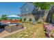 Inviting backyard featuring a hot tub, hammock, stone wall, lush greenery, and vibrant pink flowers at 2075 Old Georgian Nw Ter, Atlanta, GA 30318