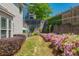 Spacious backyard with a hot tub, hammock, lush greenery, retaining wall, and privacy fence at 2075 Old Georgian Nw Ter, Atlanta, GA 30318