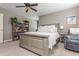 Relaxing bedroom showcasing a queen bed, ceiling fan, and sitting area, offering a serene and inviting space for rest at 2075 Old Georgian Nw Ter, Atlanta, GA 30318