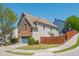 Charming two-story home has a brick facade, a two-car garage, and a well-maintained lawn on a tree-lined street at 2075 Old Georgian Nw Ter, Atlanta, GA 30318