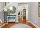 Bright foyer with hardwood floors, stylish console table, and decorative mirror creating a welcoming entrance at 2075 Old Georgian Nw Ter, Atlanta, GA 30318