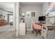 Bright home office features a work station with desk and comfortable pink chair near the primary bedroom at 2075 Old Georgian Nw Ter, Atlanta, GA 30318