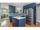Stylish kitchen featuring blue cabinets, stainless steel appliances, and a peninsula at 2075 Old Georgian Nw Ter, Atlanta, GA 30318