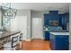 Open concept kitchen with blue cabinets, a dining area and white trim at 2075 Old Georgian Nw Ter, Atlanta, GA 30318