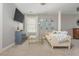 Stylish living room features a comfortable couch, television, and a gallery wall with unique framed pictures at 2075 Old Georgian Nw Ter, Atlanta, GA 30318
