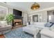 Comfortable living room with a fireplace, large windows, and a plush sectional sofa at 2075 Old Georgian Nw Ter, Atlanta, GA 30318