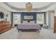 The main bedroom features tray ceilings with a decorative chandelier and ensuite bathroom at 2075 Old Georgian Nw Ter, Atlanta, GA 30318
