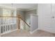Second floor landing and staircase features modern railings and new carpet at 2075 Old Georgian Nw Ter, Atlanta, GA 30318