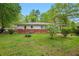 Lush backyard with mature trees surrounds this charming home featuring a well-kept lawn at 3800 Whitaker Ln, Lithia Springs, GA 30122