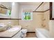 Well-maintained bathroom featuring a classic bathtub, tiled walls, and a vanity with ample storage at 3800 Whitaker Ln, Lithia Springs, GA 30122