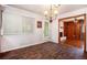 Bright dining room featuring wood floors, a modern light fixture, and an open doorway to another room at 3800 Whitaker Ln, Lithia Springs, GA 30122